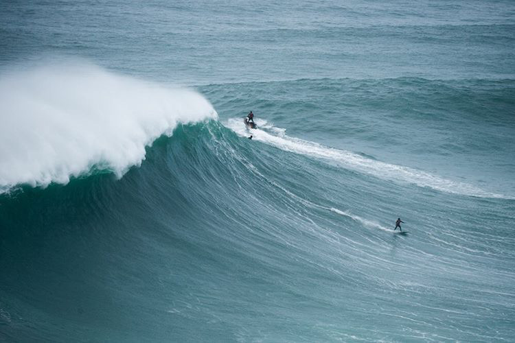 Wave chasing big wave surfer